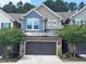Charming townhouse with a two-car garage and a mix of stone and siding exterior at 238 Alamosa Pl, Cary, NC 27519