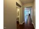 Hallway leading to a powder room and living area with hardwood floors at 238 Alamosa Pl, Cary, NC 27519