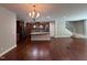 Open kitchen and living area featuring granite countertops and stainless steel appliances with hardwood flooring at 238 Alamosa Pl, Cary, NC 27519