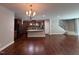 Open kitchen and living area featuring granite countertops and stainless steel appliances with hardwood flooring at 238 Alamosa Pl, Cary, NC 27519