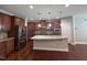 Kitchen with granite countertops, stainless steel appliances, kitchen island and dark wood cabinetry at 238 Alamosa Pl, Cary, NC 27519