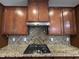 Close-up of kitchen with granite countertops, stainless steel appliances, and a tile backsplash at 238 Alamosa Pl, Cary, NC 27519