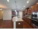 Gourmet kitchen featuring granite countertops, island and stainless steel appliances with custom cabinetry at 238 Alamosa Pl, Cary, NC 27519