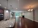 Open living area with hardwood floors, fireplace, and sliding glass doors leading to the outdoors at 238 Alamosa Pl, Cary, NC 27519