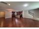 Spacious living room with hardwood floors featuring a kitchen, stairs and fireplace in an open layout at 238 Alamosa Pl, Cary, NC 27519