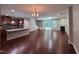 Spacious living room connected to a modern kitchen with hardwood floors and a cozy fireplace at 238 Alamosa Pl, Cary, NC 27519