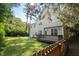 Home exterior view featuring a deck, grassy area, and a wooden fence at 2418 Mont Haven Dr, Durham, NC 27712