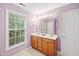 Bathroom featuring a double vanity and large window at 2418 Mont Haven Dr, Durham, NC 27712