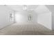 Bright and spacious bedroom features plush carpeting, two windows, and fresh white walls at 2418 Mont Haven Dr, Durham, NC 27712