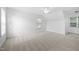 Spacious bedroom with natural light, neutral carpet, and a ceiling fan at 2418 Mont Haven Dr, Durham, NC 27712
