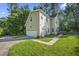 View of the home with an attached garage, complemented by a well-kept lawn at 2418 Mont Haven Dr, Durham, NC 27712