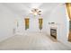 Bright living room featuring a fireplace, fan, neutral walls, and plush carpeting at 2418 Mont Haven Dr, Durham, NC 27712
