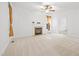 Spacious living room with a cozy fireplace, plush carpeting, and bright, neutral walls at 2418 Mont Haven Dr, Durham, NC 27712