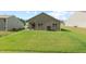 Well-maintained backyard featuring a lush lawn and a covered patio, perfect for outdoor relaxation and entertaining at 2730 Spring Valley Dr, Creedmoor, NC 27522