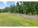 Expansive, well-maintained backyard featuring a lush, green lawn and beautiful greenery at 2730 Spring Valley Dr, Creedmoor, NC 27522