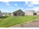 Exterior view of the back of the home with a patio and large lawn at 2730 Spring Valley Dr, Creedmoor, NC 27522