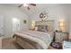 A spacious bedroom boasts a neutral palette, ceiling fan, decorative rug, and an ensuite bathroom for added convenience at 2730 Spring Valley Dr, Creedmoor, NC 27522