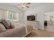Neutral toned bedroom with a ceiling fan, dresser, plush pillows, and a window offering great natural light exposure at 2730 Spring Valley Dr, Creedmoor, NC 27522
