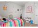 Bright bedroom featuring playful decor, a colorful striped comforter and plenty of space to read and play at 2730 Spring Valley Dr, Creedmoor, NC 27522