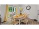 Dining area next to sliding glass doors with a view of the back yard and a distressed wood dining table at 2730 Spring Valley Dr, Creedmoor, NC 27522