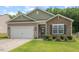 Charming single-story home featuring stone and tan siding with a well-manicured front lawn at 2730 Spring Valley Dr, Creedmoor, NC 27522