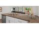 The kitchen island has a granite countertop with a double sink and a dining area with a sliding door to the back yard at 2730 Spring Valley Dr, Creedmoor, NC 27522