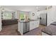 Open-concept kitchen with a breakfast bar island and view into the living room at 2730 Spring Valley Dr, Creedmoor, NC 27522