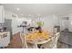 Open kitchen and dining area featuring an island with granite countertops, stainless appliances, and wood dining table at 2730 Spring Valley Dr, Creedmoor, NC 27522