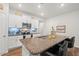 A kitchen island has granite countertop with a double sink, with seating for two on black leather chairs at 2730 Spring Valley Dr, Creedmoor, NC 27522