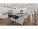 Bright kitchen with white cabinets, granite countertops, island with seating and stainless steel appliances at 2730 Spring Valley Dr, Creedmoor, NC 27522