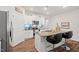 A bright kitchen with white cabinets, granite countertops, an island with seating, and stainless steel appliances at 2730 Spring Valley Dr, Creedmoor, NC 27522