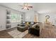 Cozy living room featuring a plush sectional sofa, wood flooring and natural light at 2730 Spring Valley Dr, Creedmoor, NC 27522