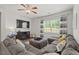 Spacious living room with comfortable seating, a fireplace, and a large window at 2730 Spring Valley Dr, Creedmoor, NC 27522