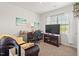 A home office boasts a cozy seating area, an organized desk space, great natural light, and modern decor at 2730 Spring Valley Dr, Creedmoor, NC 27522