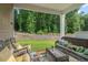 Relaxing covered patio with comfortable seating and view of lush green backyard at 2730 Spring Valley Dr, Creedmoor, NC 27522