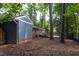 Expansive backyard features a deck, mature trees, and lush greenery, creating a serene outdoor oasis at 2801 E Shoreham St, Durham, NC 27707