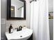 Bathroom vanity with stylish fixtures and neutral wall tile at 2801 E Shoreham St, Durham, NC 27707