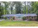 Attractive single-story brick home featuring lush landscaping and a well-manicured front lawn at 2801 E Shoreham St, Durham, NC 27707