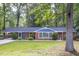 Charming single-story brick home with lush green lawn, landscaping, and inviting curb appeal at 2801 E Shoreham St, Durham, NC 27707