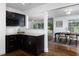 Open kitchen with dark cabinets and granite countertops connects seamlessly to the dining area at 2801 E Shoreham St, Durham, NC 27707