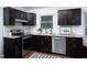 Stylish kitchen with dark cabinetry, stainless steel appliances, and granite countertops at 2801 E Shoreham St, Durham, NC 27707