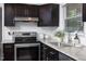 Modern kitchen features stainless steel appliances and granite countertops, offering both style and functionality at 2801 E Shoreham St, Durham, NC 27707