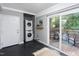 Laundry room with a stacked washer and dryer and access to the outdoor deck at 2801 E Shoreham St, Durham, NC 27707