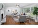 Open living room with lots of light features a fireplace, hardwood floors, and stylish decor at 2801 E Shoreham St, Durham, NC 27707