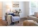 Comfortable armchairs sit on top of a decorative rug in the open and airy living room at 2801 E Shoreham St, Durham, NC 27707
