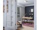 Home office with desk, wood shelving, and natural light streaming through the windows at 2801 E Shoreham St, Durham, NC 27707