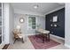 Home office with cozy décor features an area rug and a striking dark accent wall at 2801 E Shoreham St, Durham, NC 27707