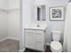 A well-lit bathroom featuring a vanity with storage and essential fixtures at 290 Grand Silo Rd, Raleigh, NC 27603
