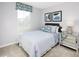 Cozy bedroom with modern decor, striped bedding, and a mirrored nightstand at 290 Grand Silo Rd, Raleigh, NC 27603