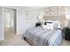 Bedroom featuring a comfortable bed with striped bedding and neutral decor at 290 Grand Silo Rd, Raleigh, NC 27603